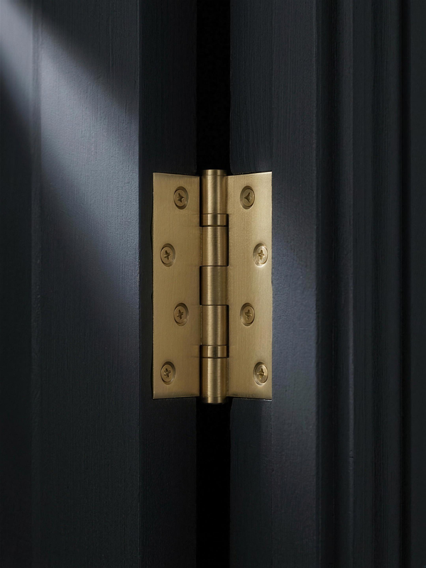 Cast Hinge in Cast Brass, installed on a charcoal door