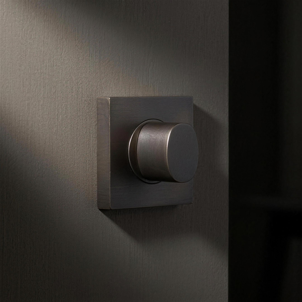 Filo Turn Square mounted on a door in Cast Bronze