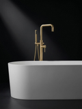 Fonte Bath Shower Mixer in Cast Brass beside a freestanding bath