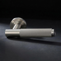 Asta Lever in Cast Nickel, knurled bar lever on a round rose