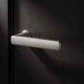 Velo Lever in Cast Nickel on a flush smoked-oak door