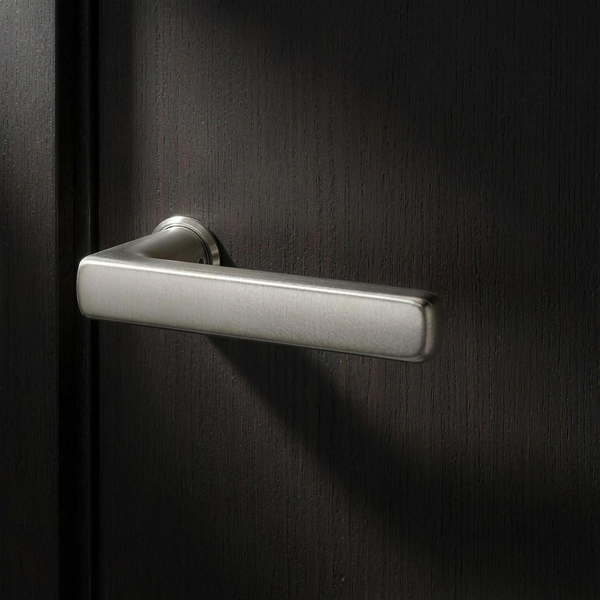 Velo Lever in Cast Nickel on a flush smoked-oak door