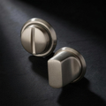 Velo Turn set in Cast Nickel — thumb turn and coin release on honed charcoal